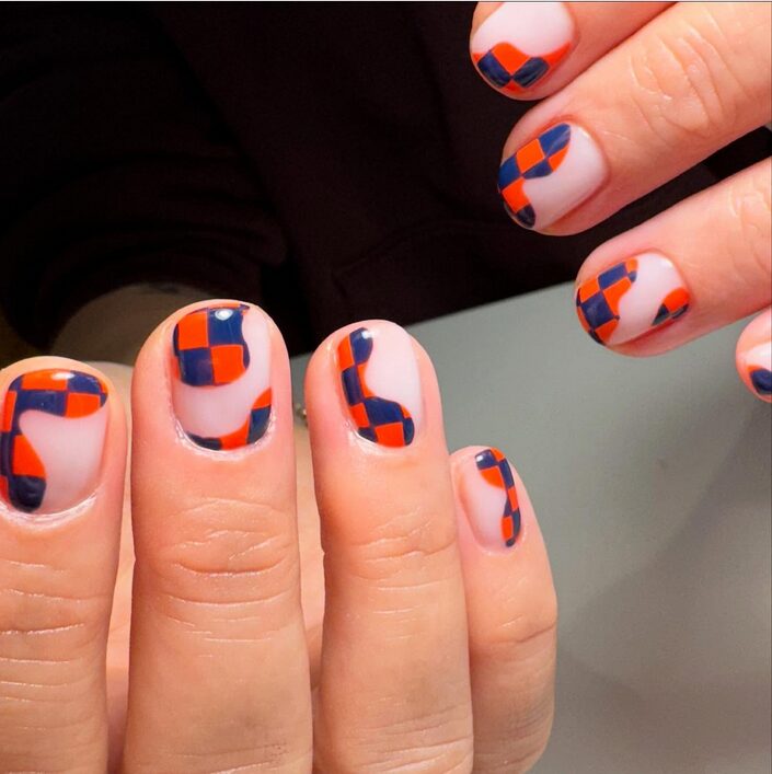 orange and nude checkerboard nail design on square nails