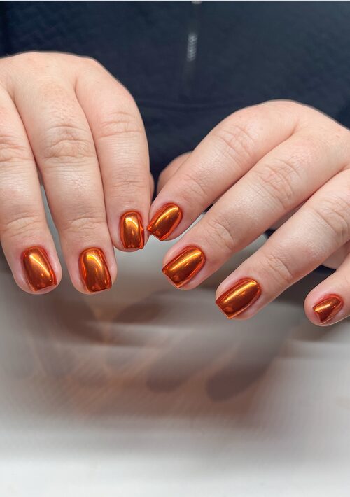 Burnt orange chrome nails with metallic mirror finish