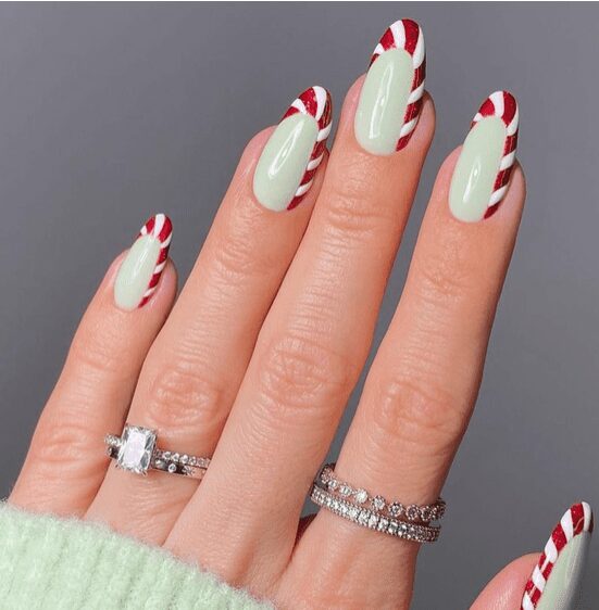 closeup of red and white nails with swirl tips
