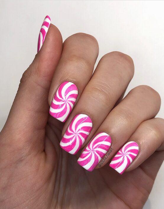 Pink and white nails with pastel swirls