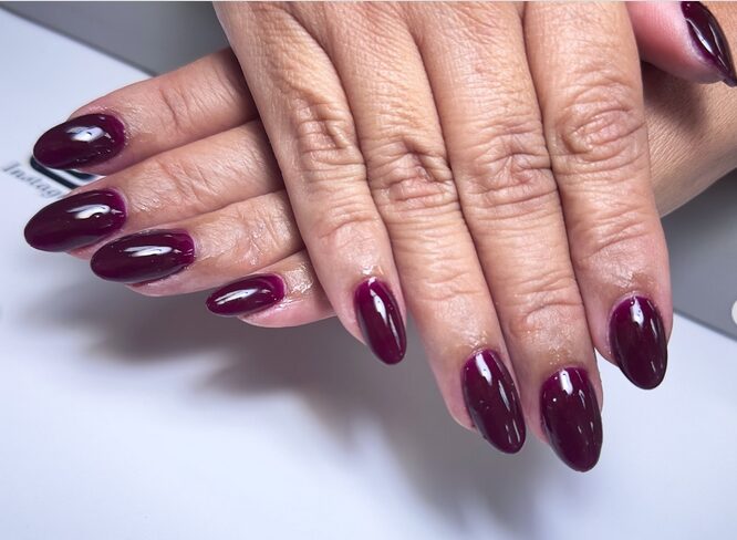 Deep plum and wine-colored fall nails with a subtle shimmer