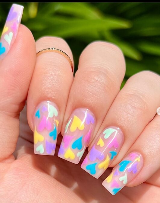 colorful nails with rainbow heart designs, bright and cheerful multicolor heart manicure