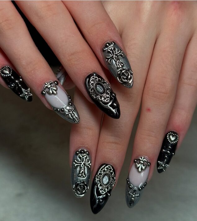 Black nails with rhinestone accents for glam gothic manicure.