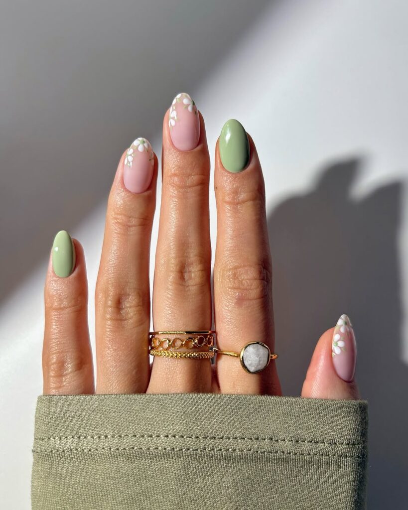 spring nails featuring sage green polish and white daisy floral accents