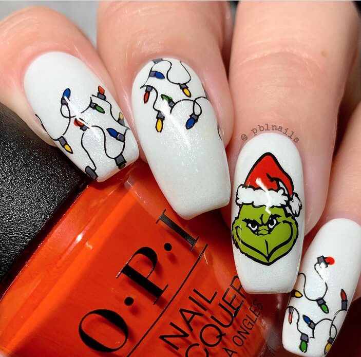 Grinch-inspired nails with red Santa hat designs
