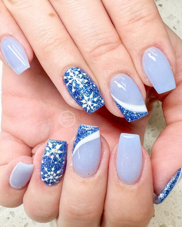 winter nails with delicate white snowflake nail art accents