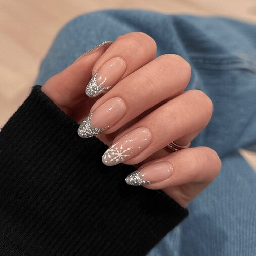 nails with small star accents on a soft, shimmery base