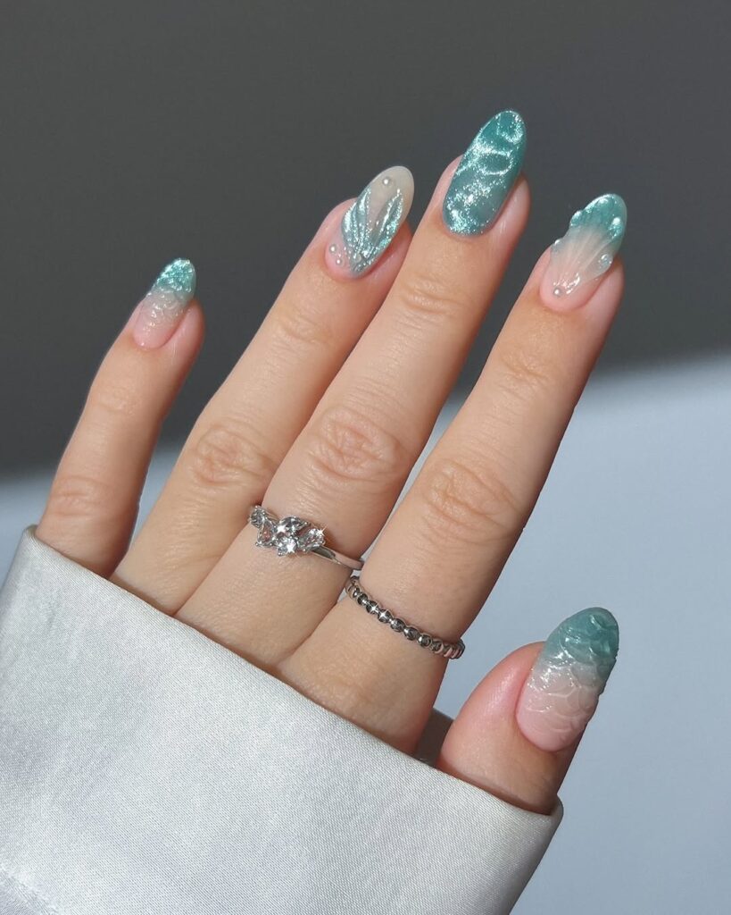 nails with teal shimmer gradient and textured glossy design