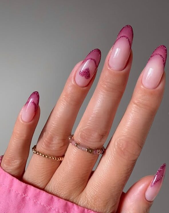 minimalist nude nails with a small red heart accent on one nail