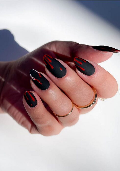 Dark red vampire-inspired nails with sharp tips