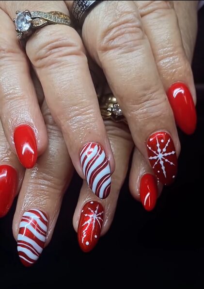 nails with snowflake detailing and red-white peppermint stripes