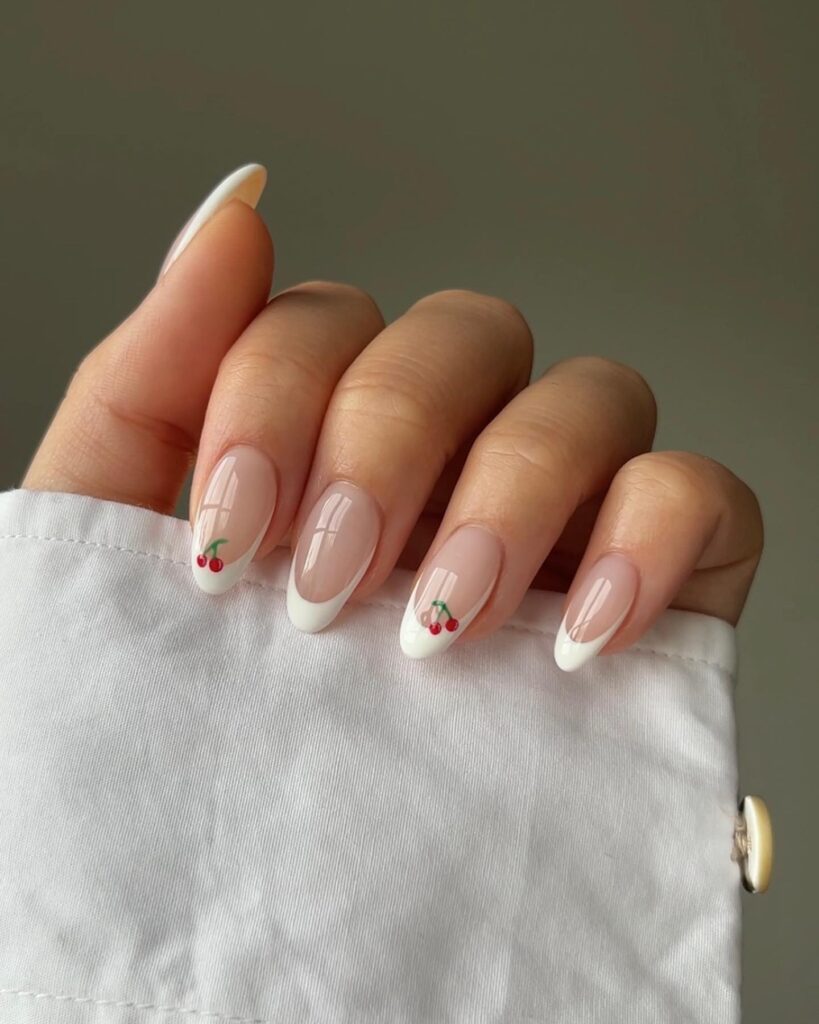 nails with white French tips and small red cherry accent art