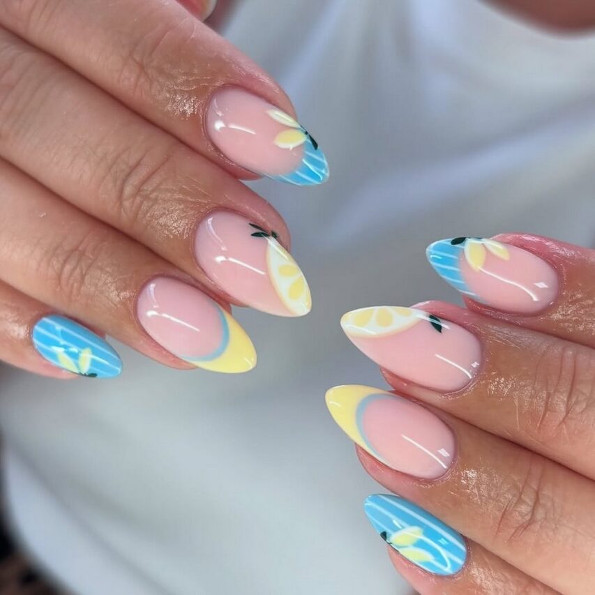 Blue and yellow French tips with lemon slice nail art