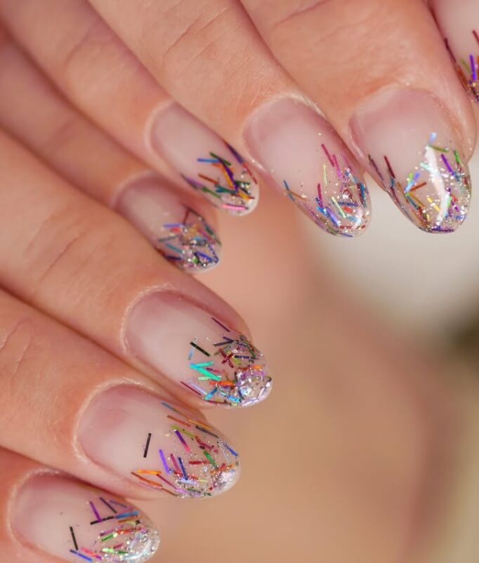 Clear French tips with colorful confetti glitter