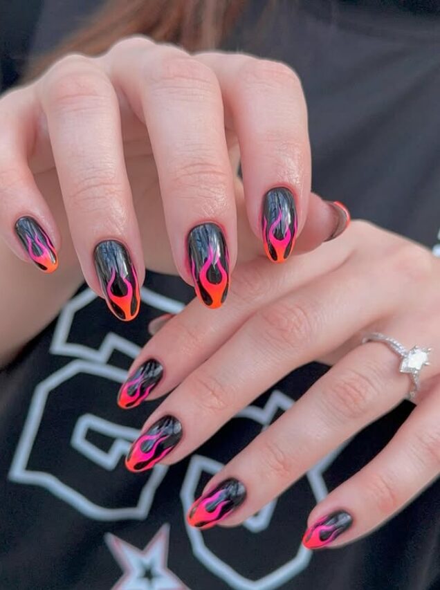 Black nails with neon flame French tips in pink and orange
