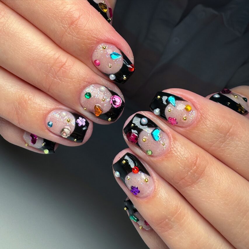 black French tips with colorful rhinestones and glitter