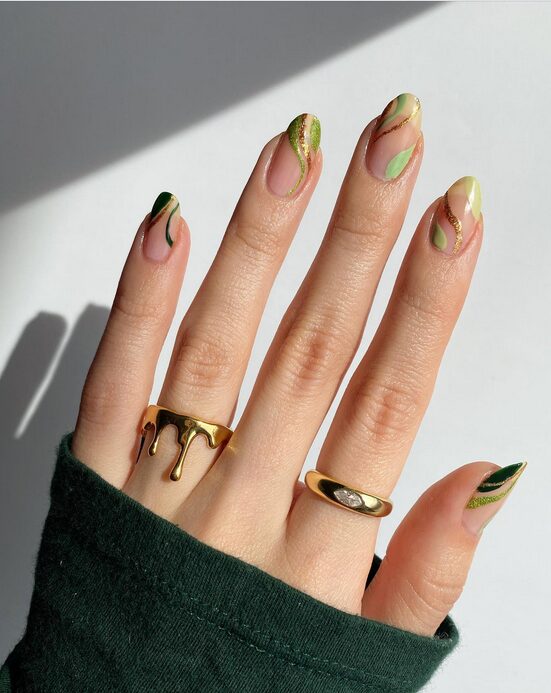 nails with green and gold abstract swirl designs