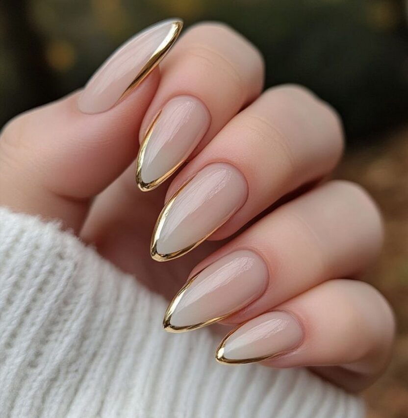 nails featuring abstract gold chrome tips, line art, pearls