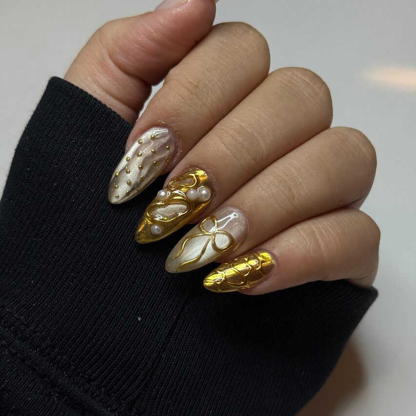 gold and pearl 3D nails with velvet shimmer and intricate raised designs