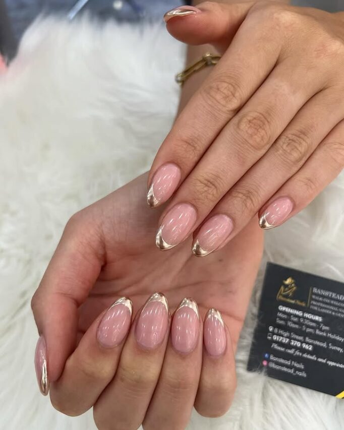 Soft pink almond nails with mirror chrome gold French tips