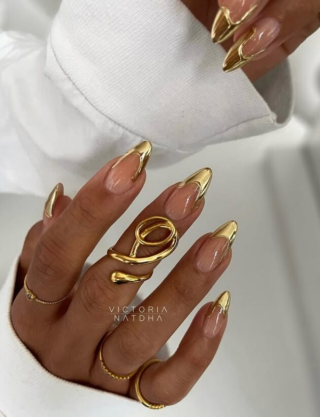 nails with molten gold drip French tips and high-shine finish