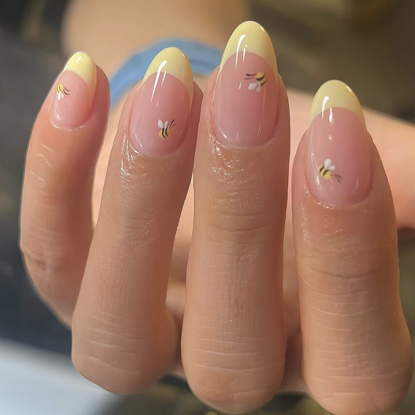 Yellow French tips with tiny bee designs
