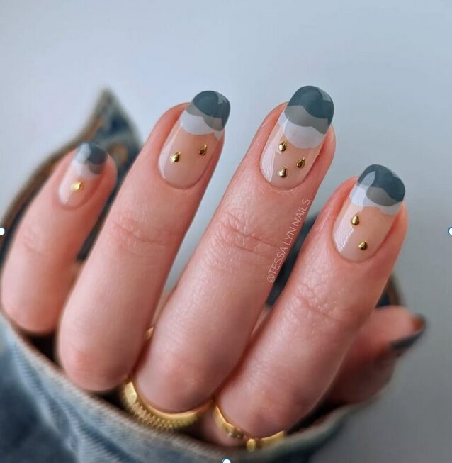 Neutral nails with abstract gray French tips and small gold stud accents