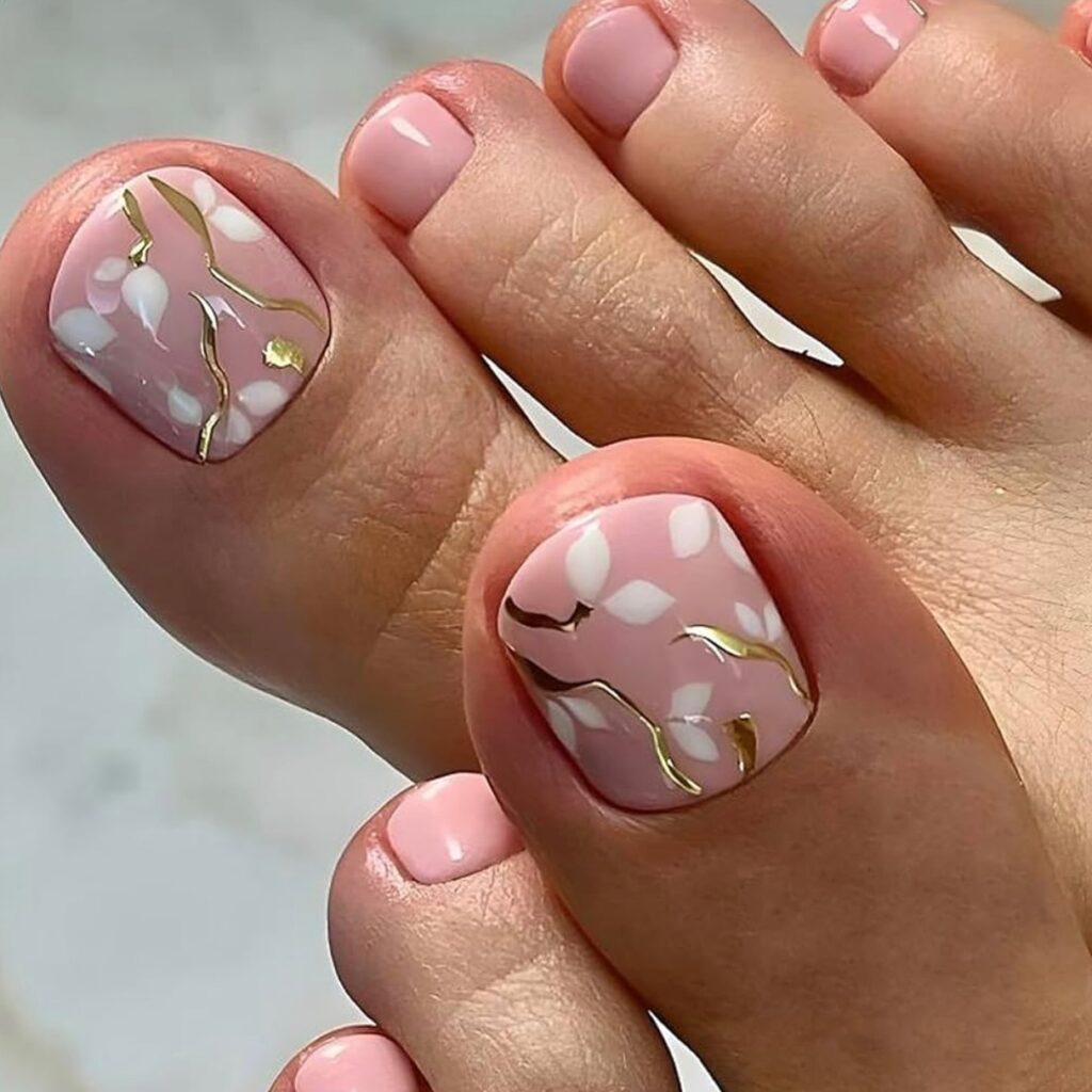 baby pink spring toe nails with white petals and gold detail