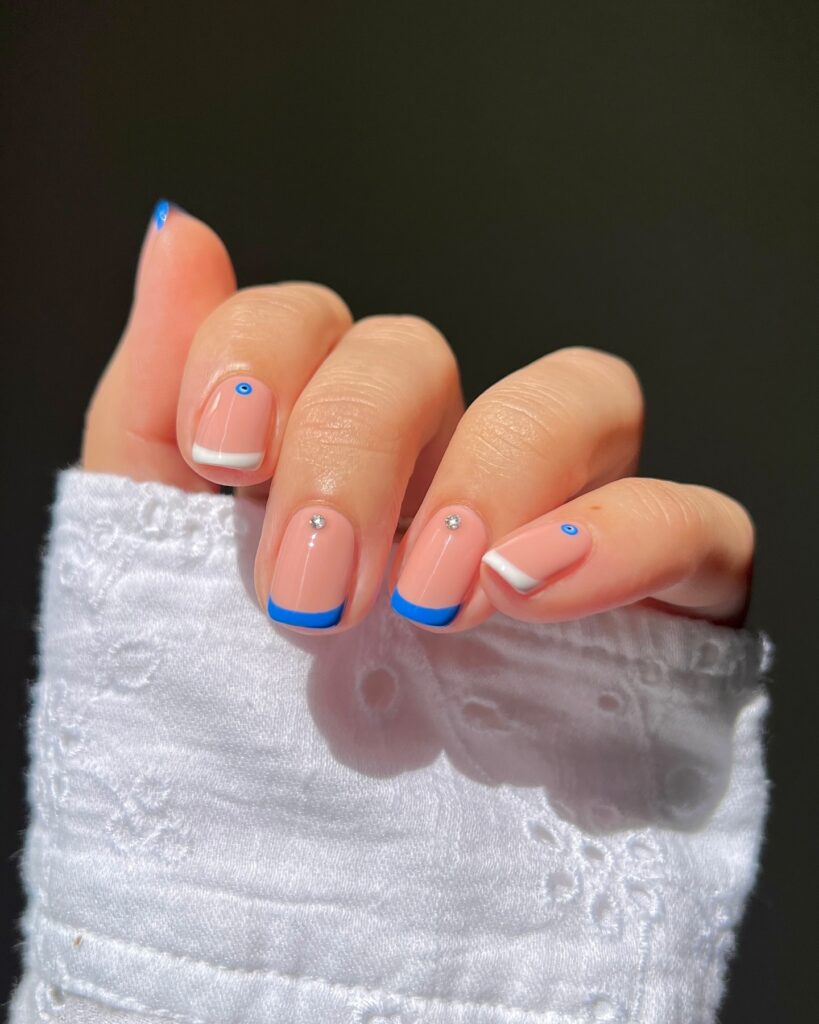 blue French tips with evil eye detail