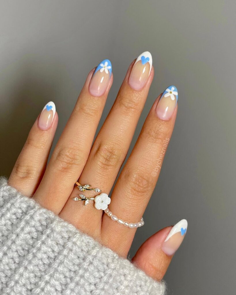 white French tips with blue hearts and daisies