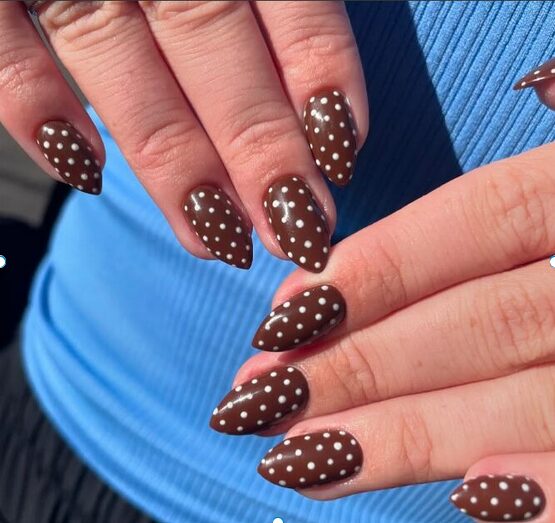 white polka dots on brown nails