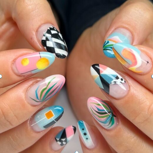 colorful nails with mixed patterns including geometric shapes, swirls, and checkerboard designs