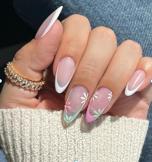French tip nails with white, pink, and green accents and delicate floral nail art