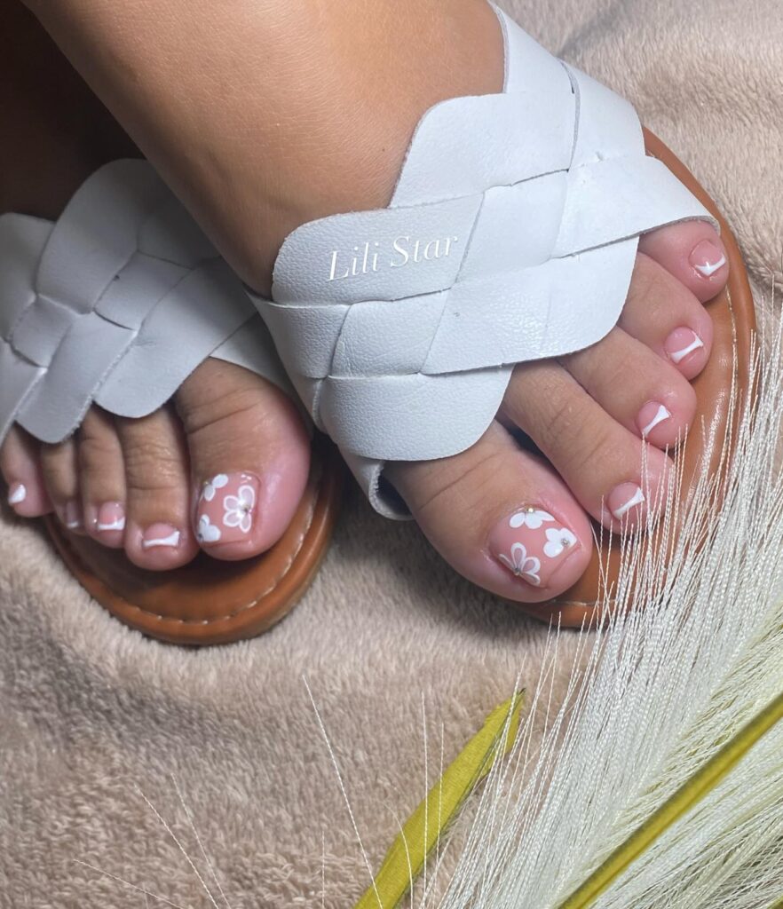 glossy nude pedicure with pink shimmer