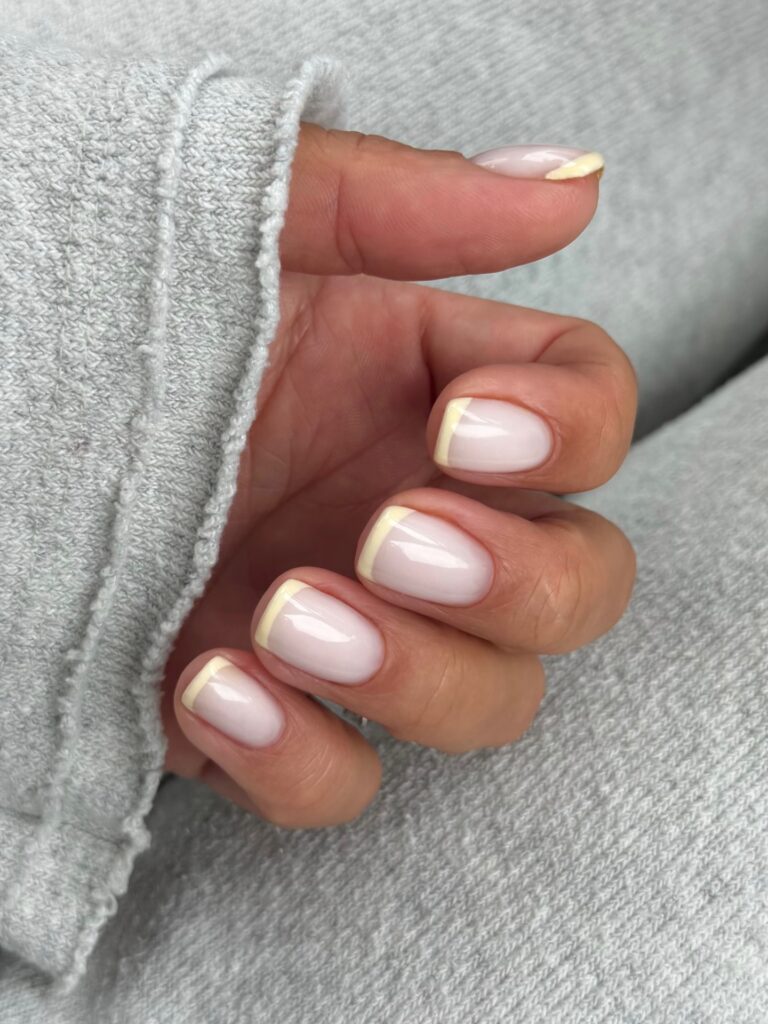 soft yellow French tips on short square nails