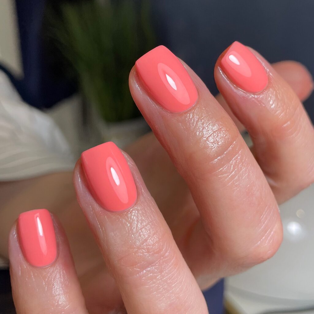 Glossy solid coral pink nails