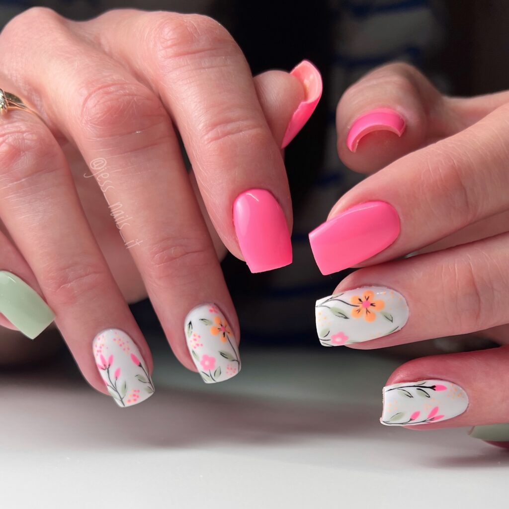 Neon coral nails with white botanical floral accents