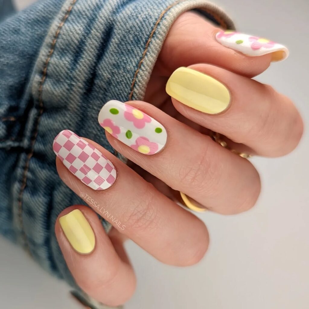 Yellow nails with pink checkerboard and floral art
