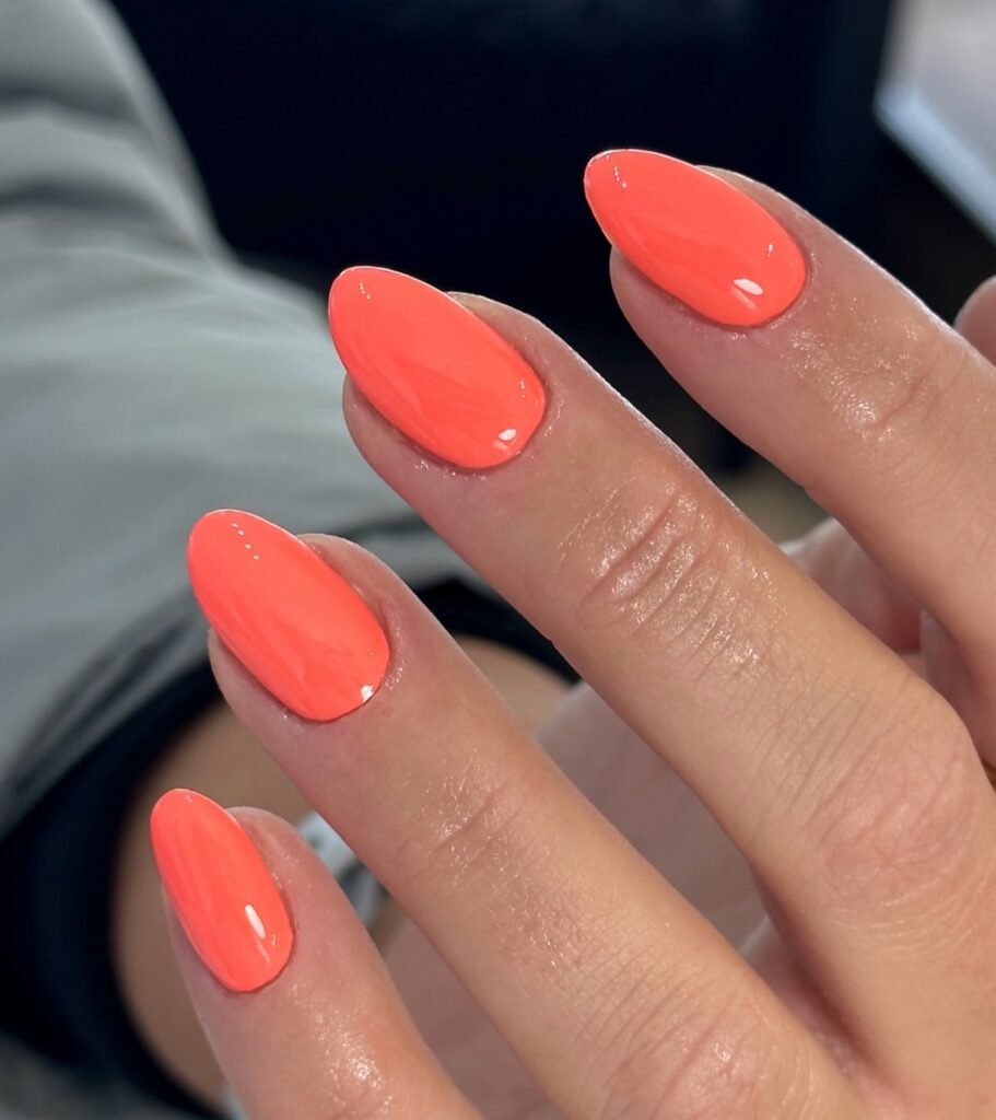 Glossy neon coral almond nails