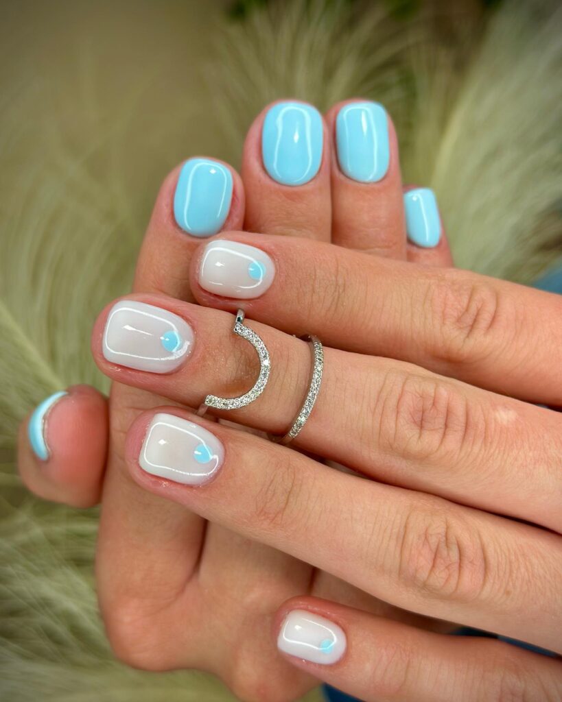 Baby blue nails with white French tip and blue dot