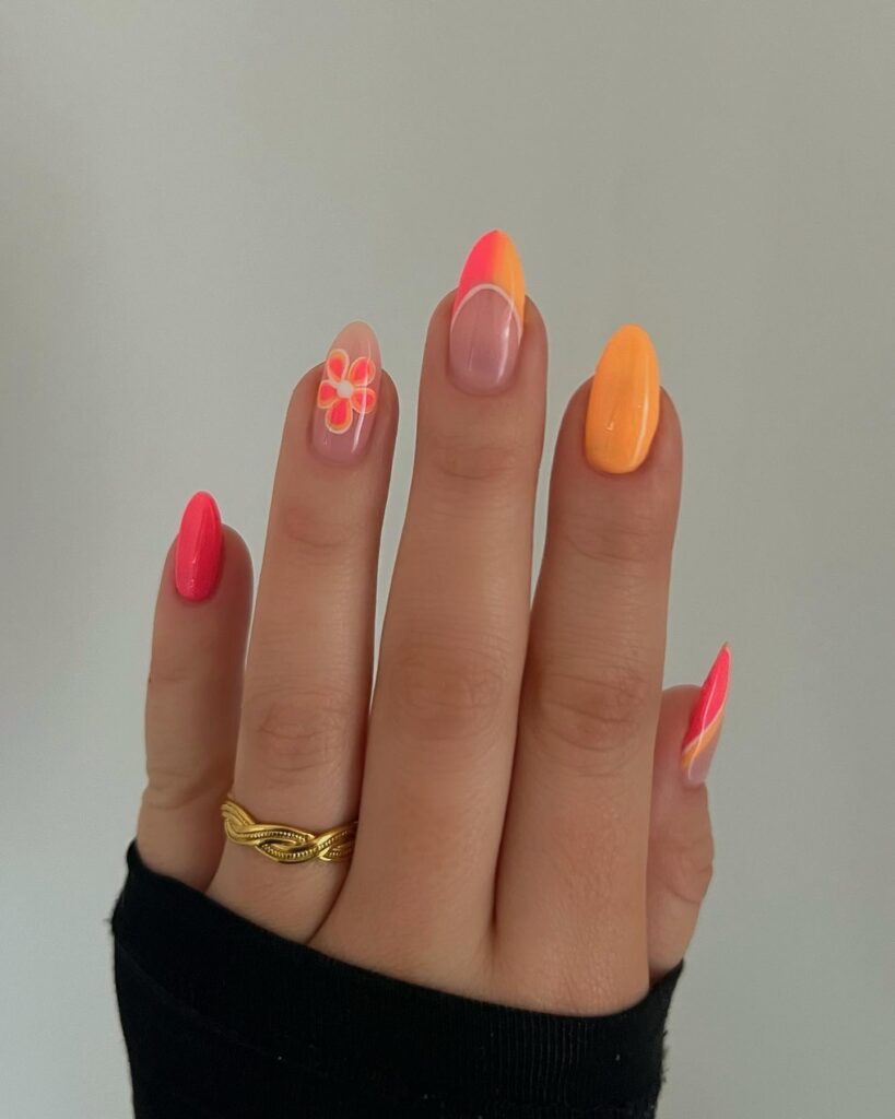 Neon coral and orange nails with flower accent