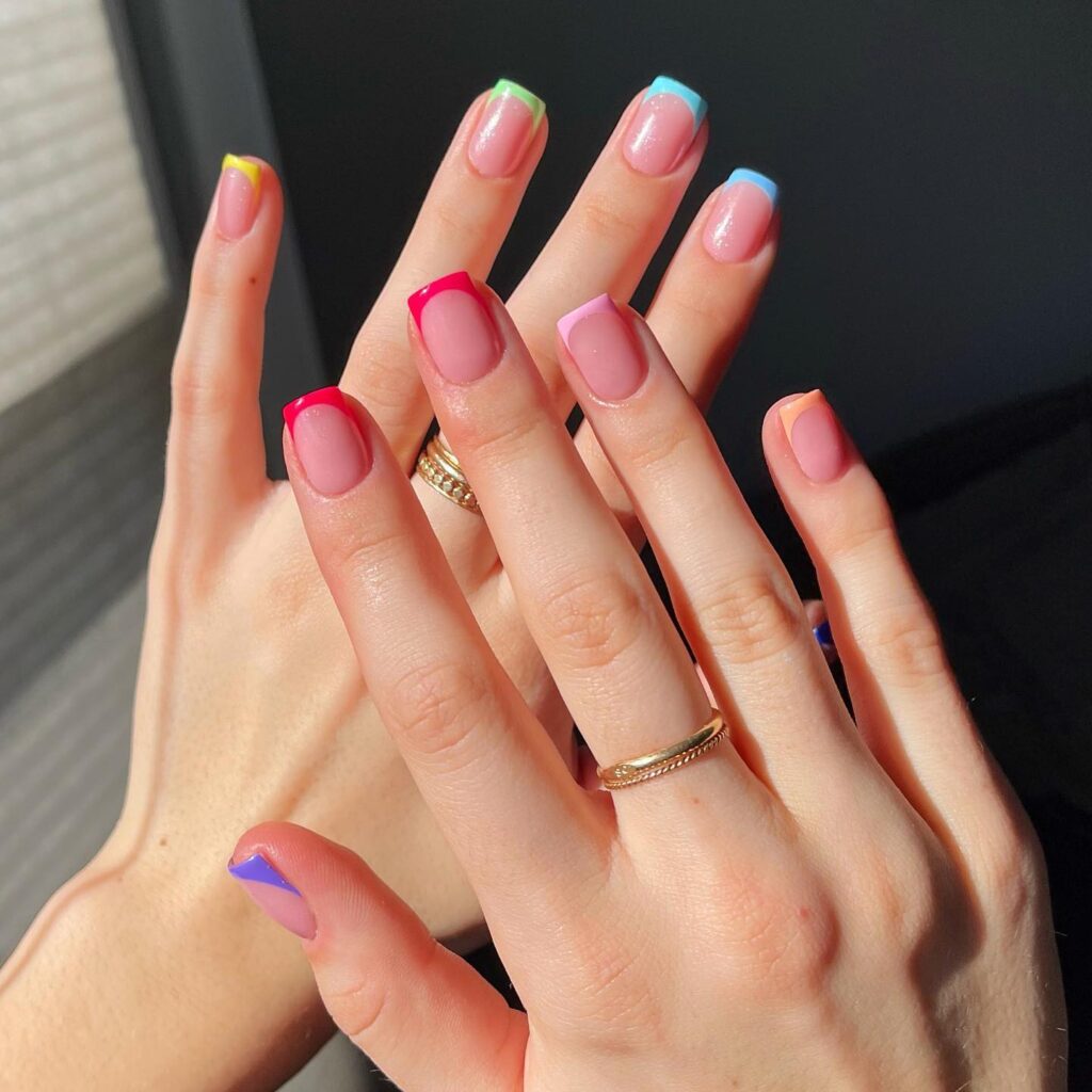 Nude nails with rainbow coloured French tips