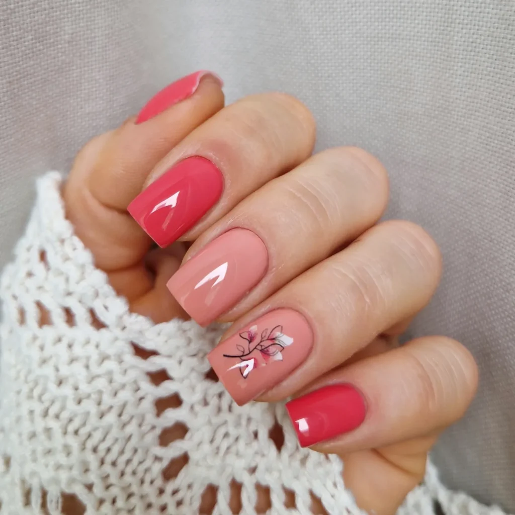 Coral and blush nails with floral branch accent