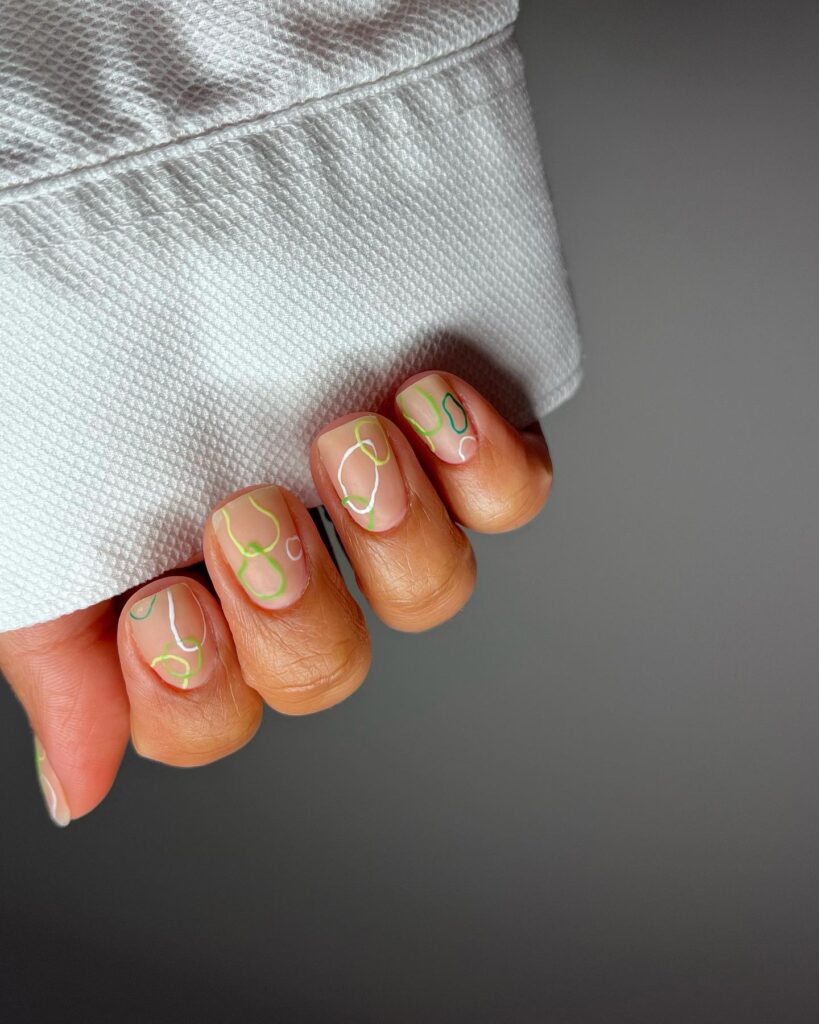 Sheer nails with green and white abstract line art