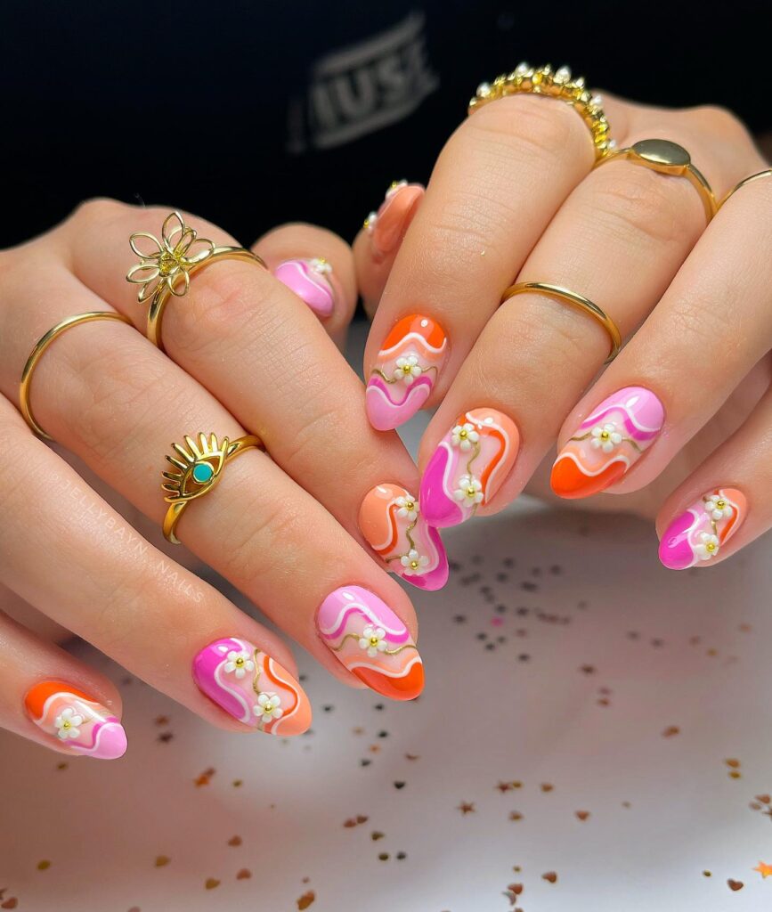 Coral and pink swirl nails with 3D daisy charms