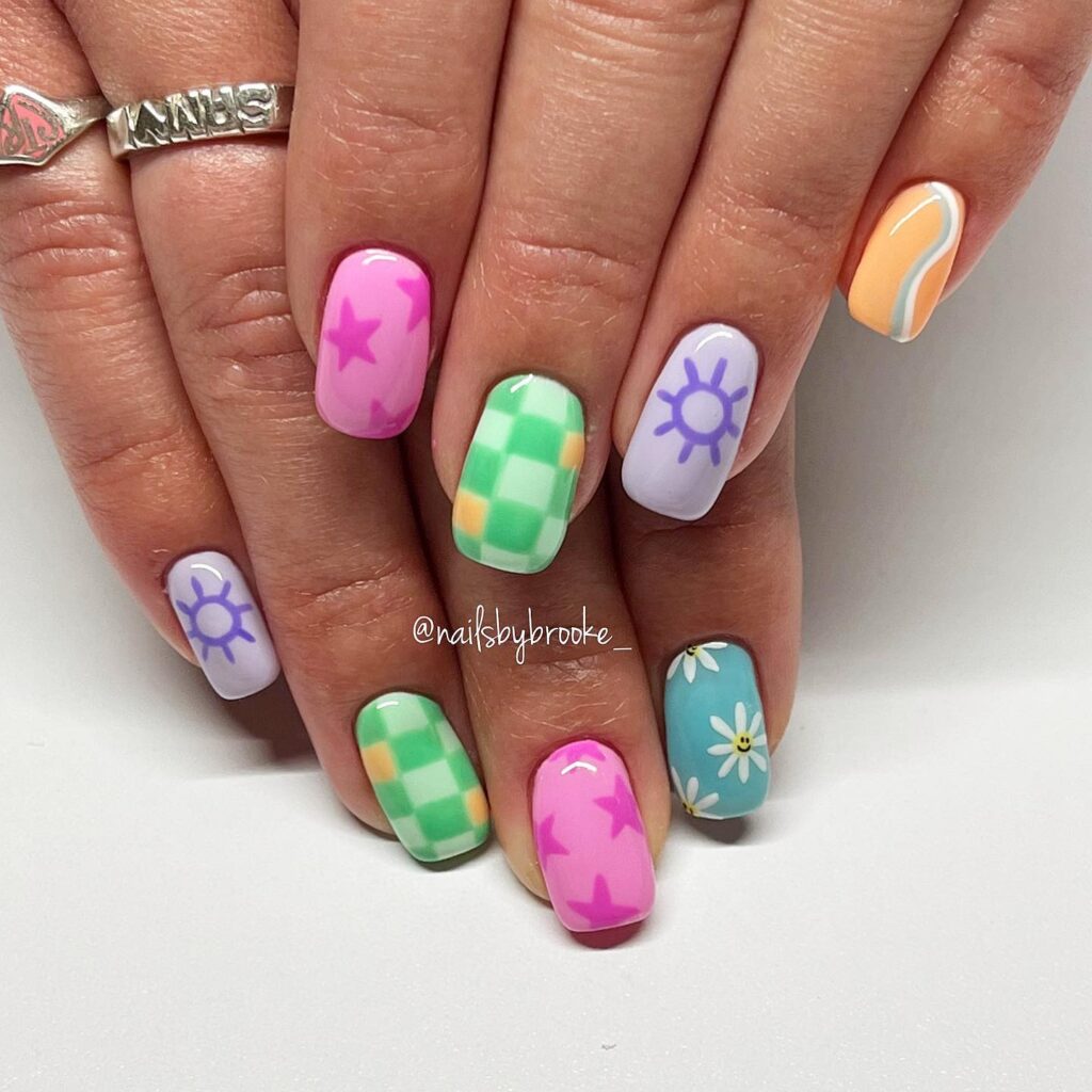 Nails with stars suns daisies and checkerboard art