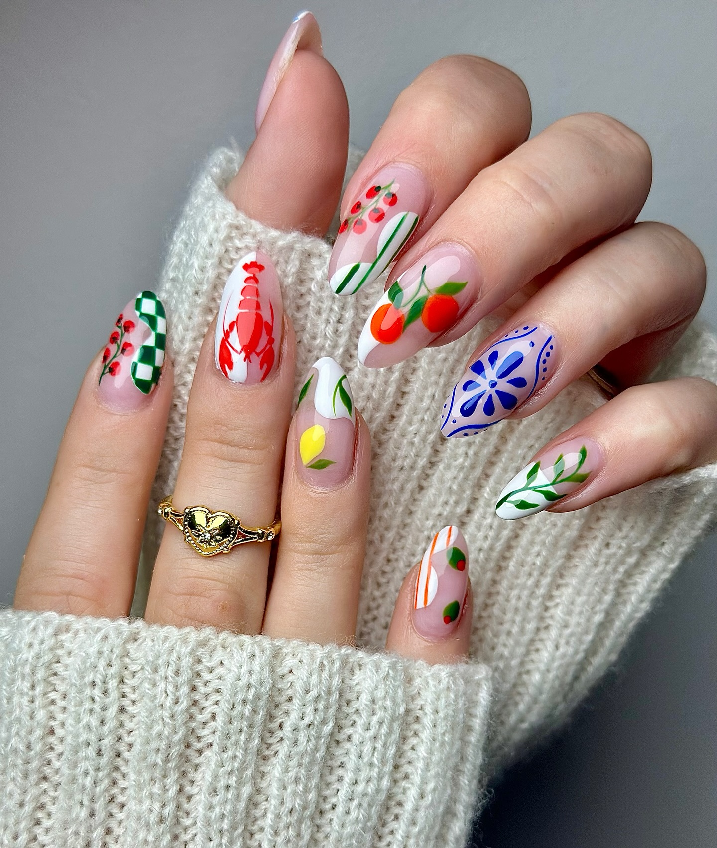 Almond nails with lobster lemon and blue Amalfi tile designs