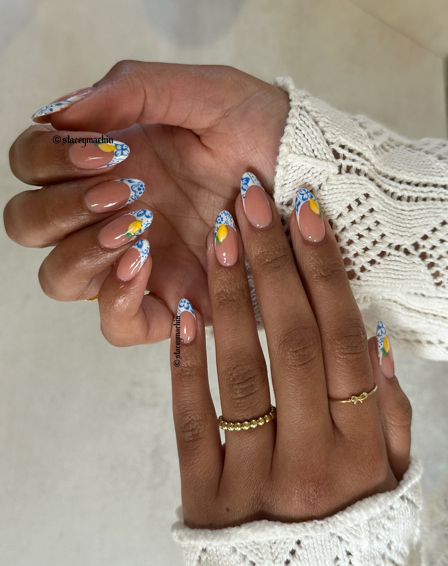 Long almond nails with blue and white Delft tile French tips and painted lemons