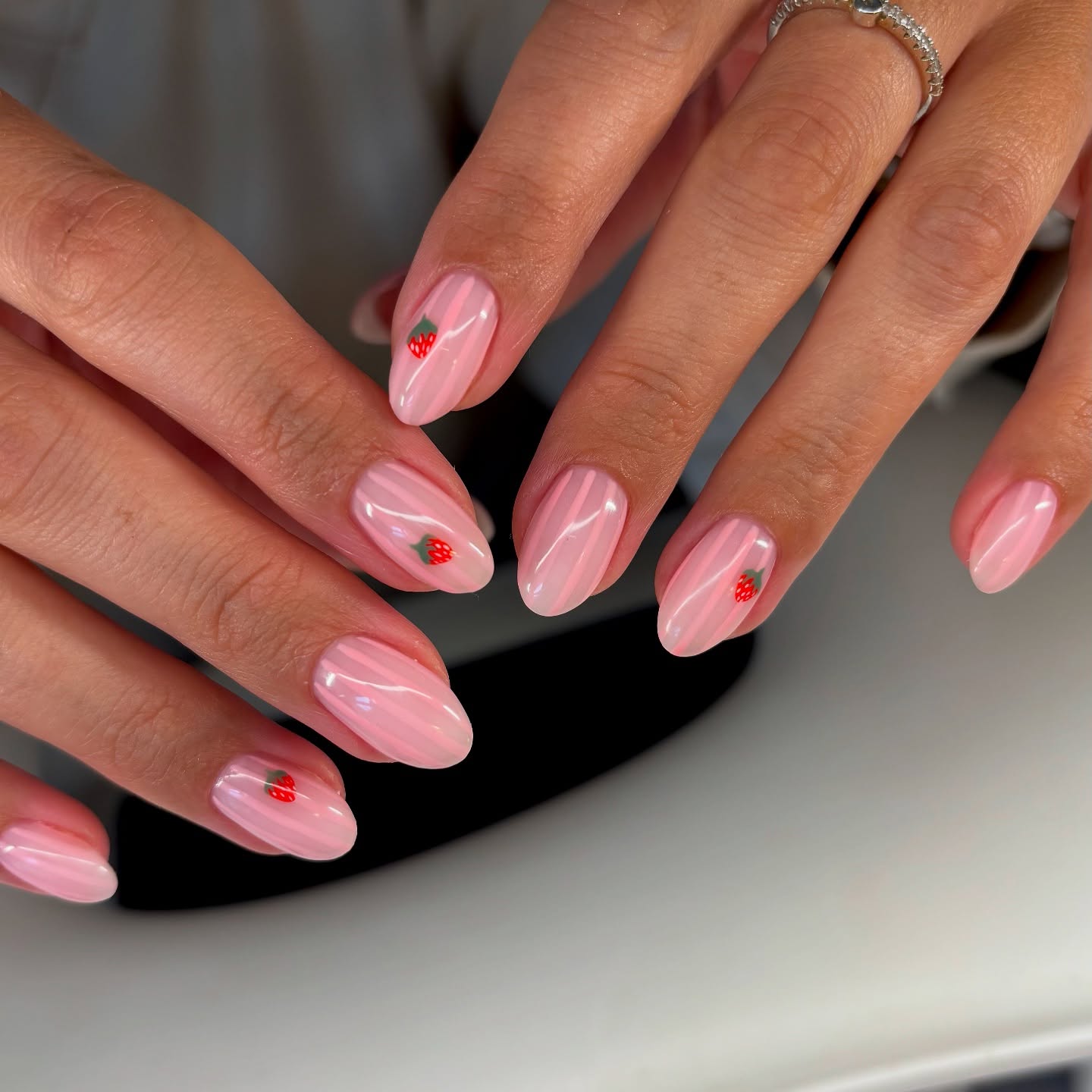 Aurora glazed pink almond nails with strawberry accents