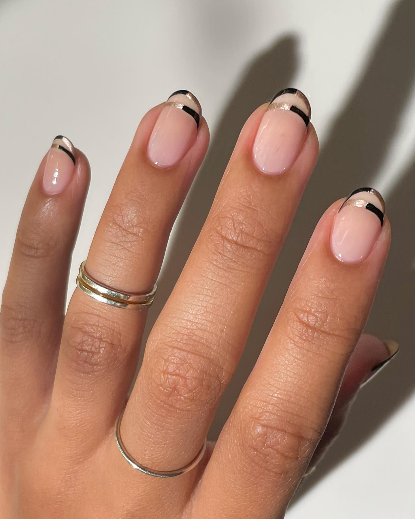 Thin black French tips with gold shimmer detail